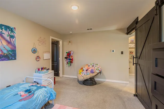 a bedroom with two beds and a dresser