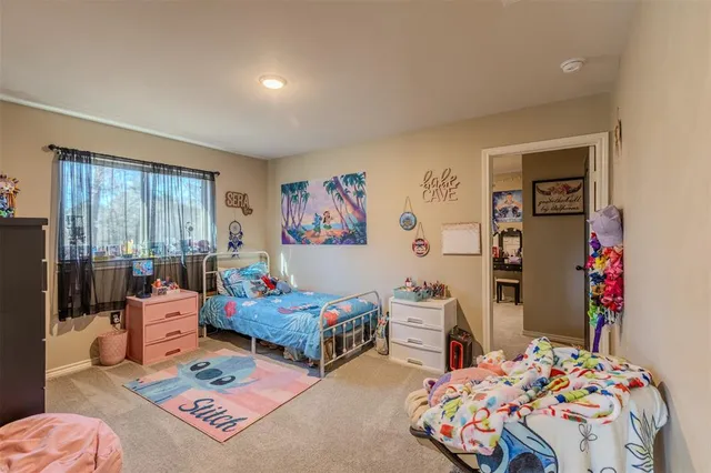 a room with a bed and a television