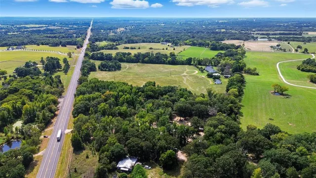 a backyard of a house with lots of green space and garden