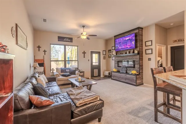 a living room with furniture a fireplace and a flat screen tv