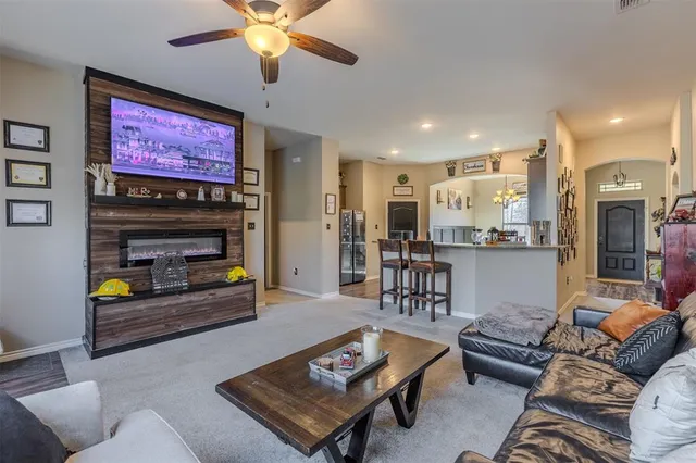 a living room with furniture and kitchen view