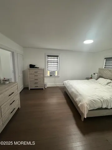 a bedroom with a bed and dresser