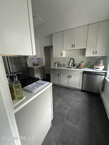 a kitchen with a stove a sink and a refrigerator