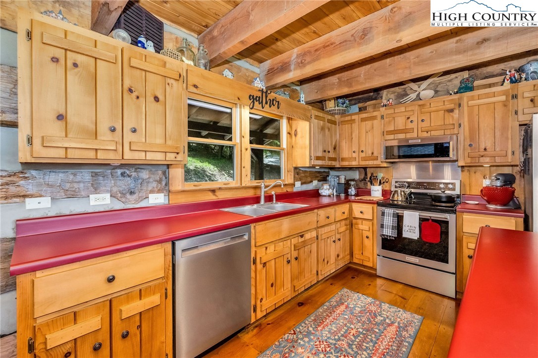289 Summit Drive Todd, NC 28684 - Photo 11 of 42 a kitchen with stainless steel appliances granite countertop a stove sink and cabinets