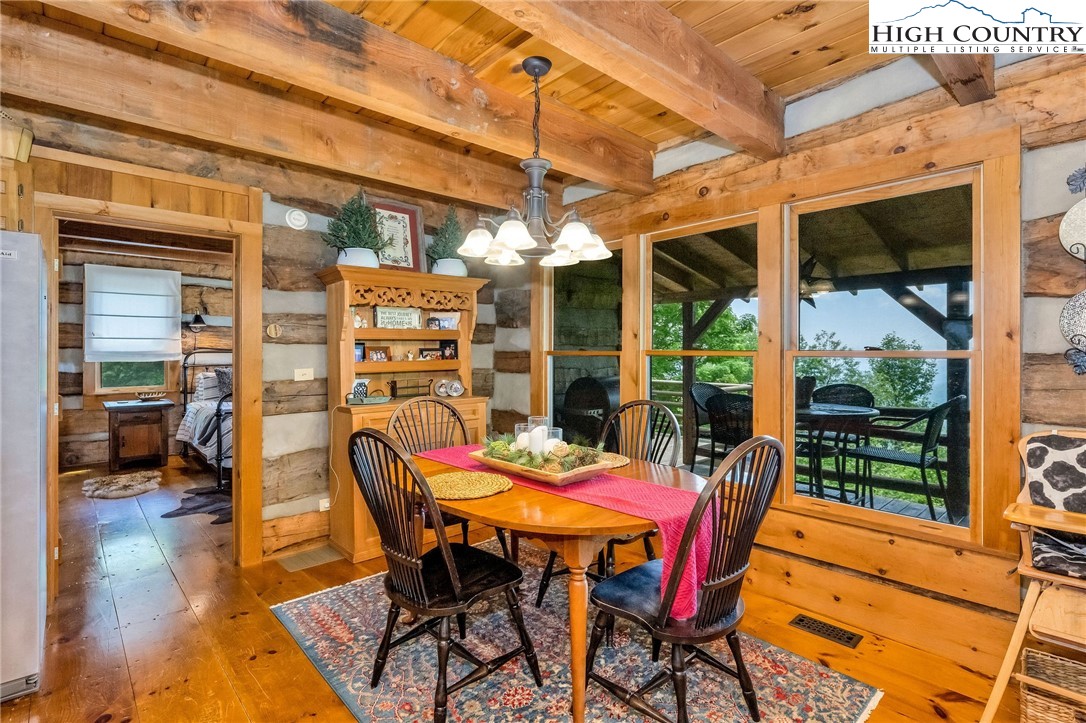 289 Summit Drive Todd, NC 28684 - Photo 14 of 42 a view of a dining room with furniture and wooden floor