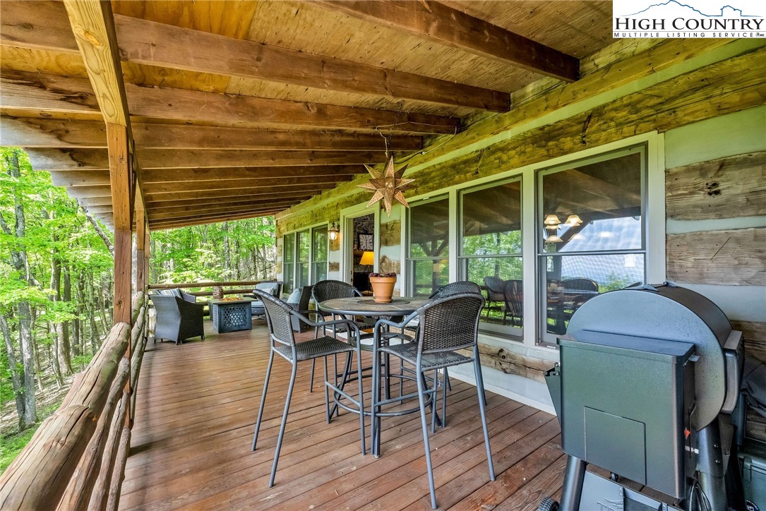 289 Summit Drive Todd, NC 28684 - Photo 17 of 42 a view of a patio with table and chairs and wooden floor