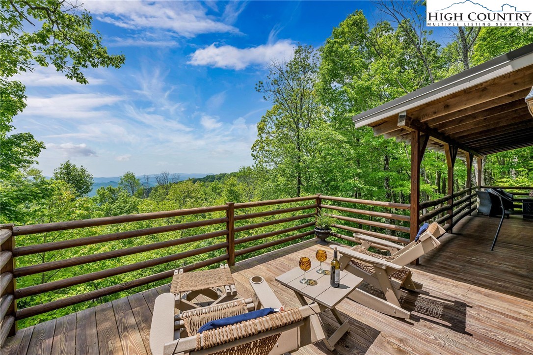 289 Summit Drive Todd, NC 28684 - Photo 21 of 42 a view of a balcony with wooden floor and outdoor seating