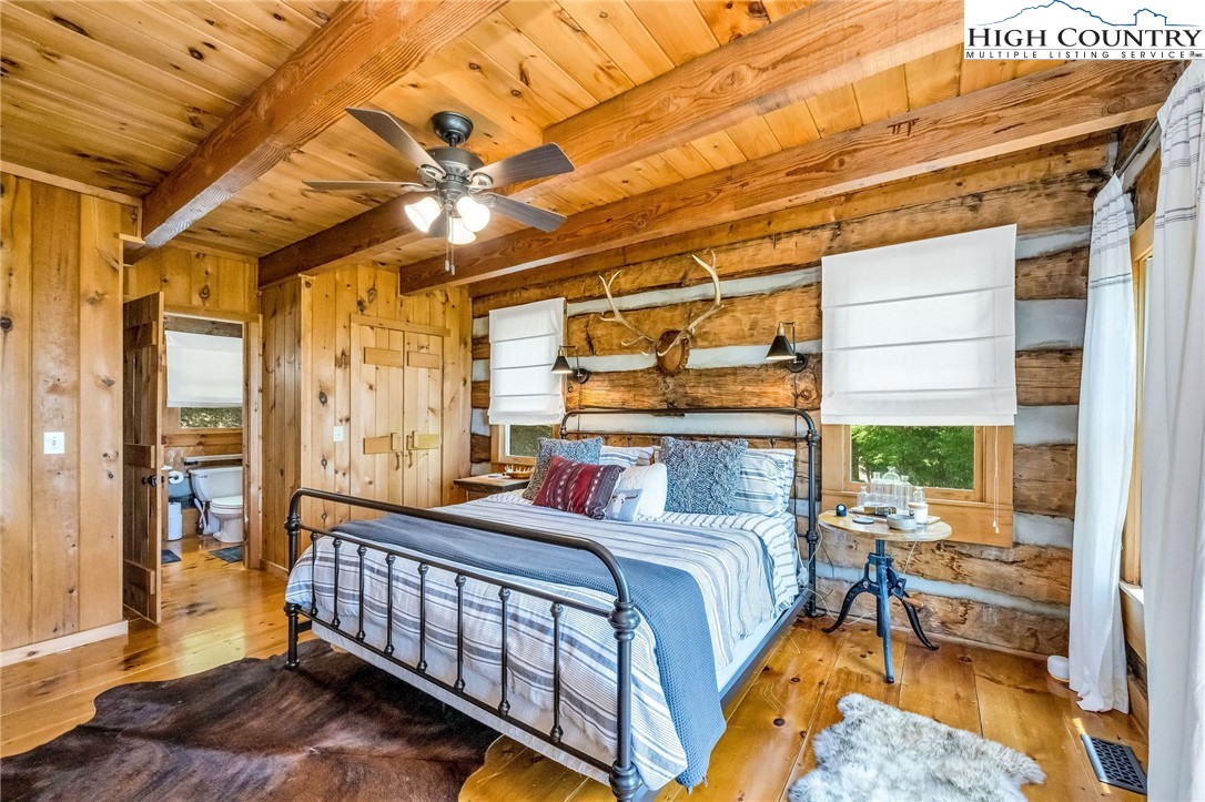 289 Summit Drive Todd, NC 28684 - Photo 23 of 42 a bedroom with a bed and a chandelier