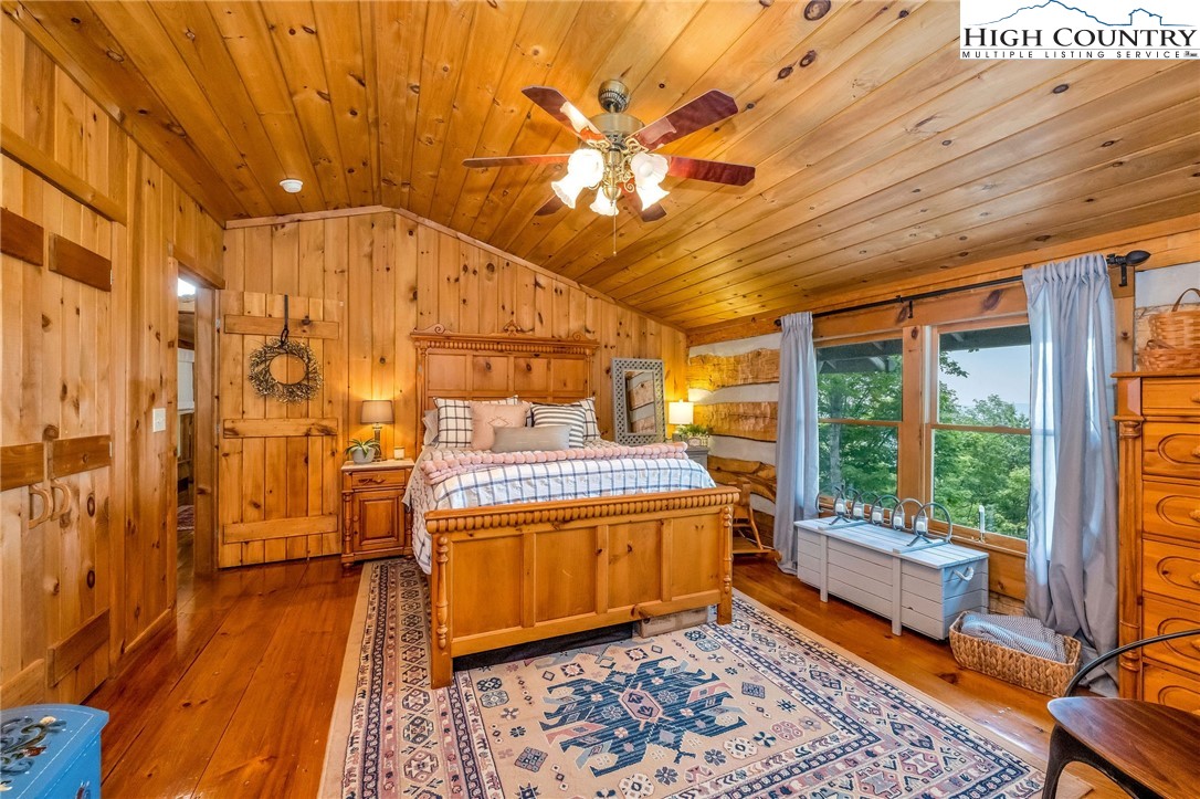 289 Summit Drive Todd, NC 28684 - Photo 29 of 42 a view of a bedroom with a bed and wooden floor