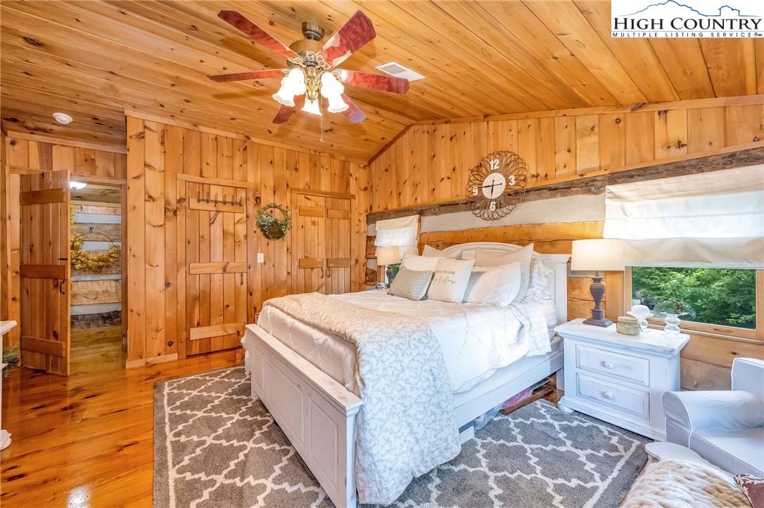 289 Summit Drive Todd, NC 28684 - Photo 34 of 42 a bedroom with a bed and wooden floor