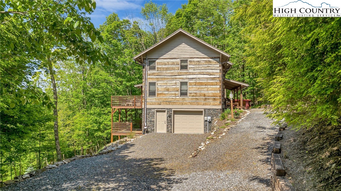 289 Summit Drive Todd, NC 28684 - Photo 5 of 42 a front view of a house with a yard and garage