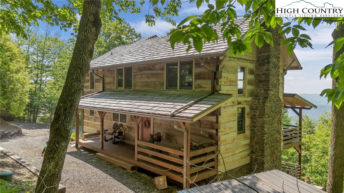 289 Summit Drive Todd, NC 28684 - Photo 6 of 42 a view of house with a small yard and a large tree