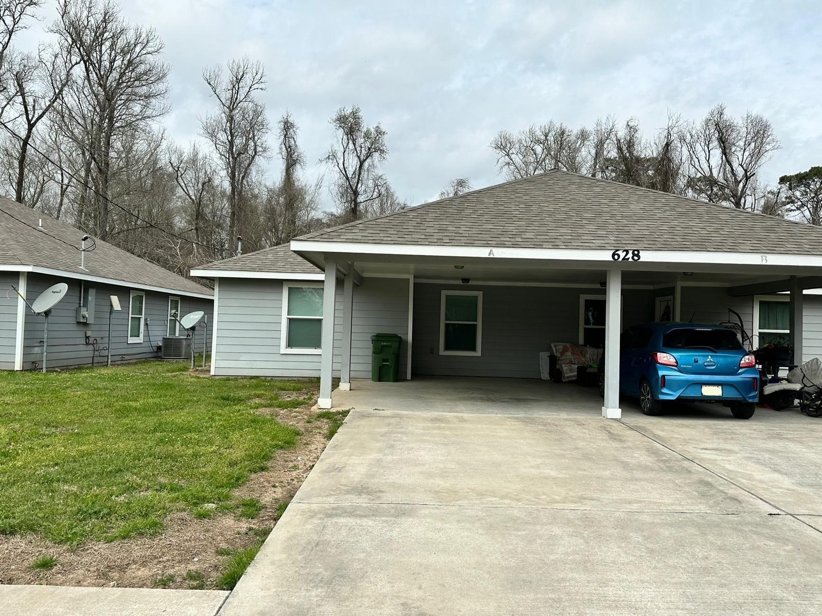 628 Luke Street, Unit A Dayton, TX 77535 - Photo 1 of 26 a view of a house with a garden and pathway