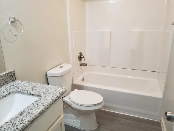 a bathroom with a sink a toilet and a bathtub