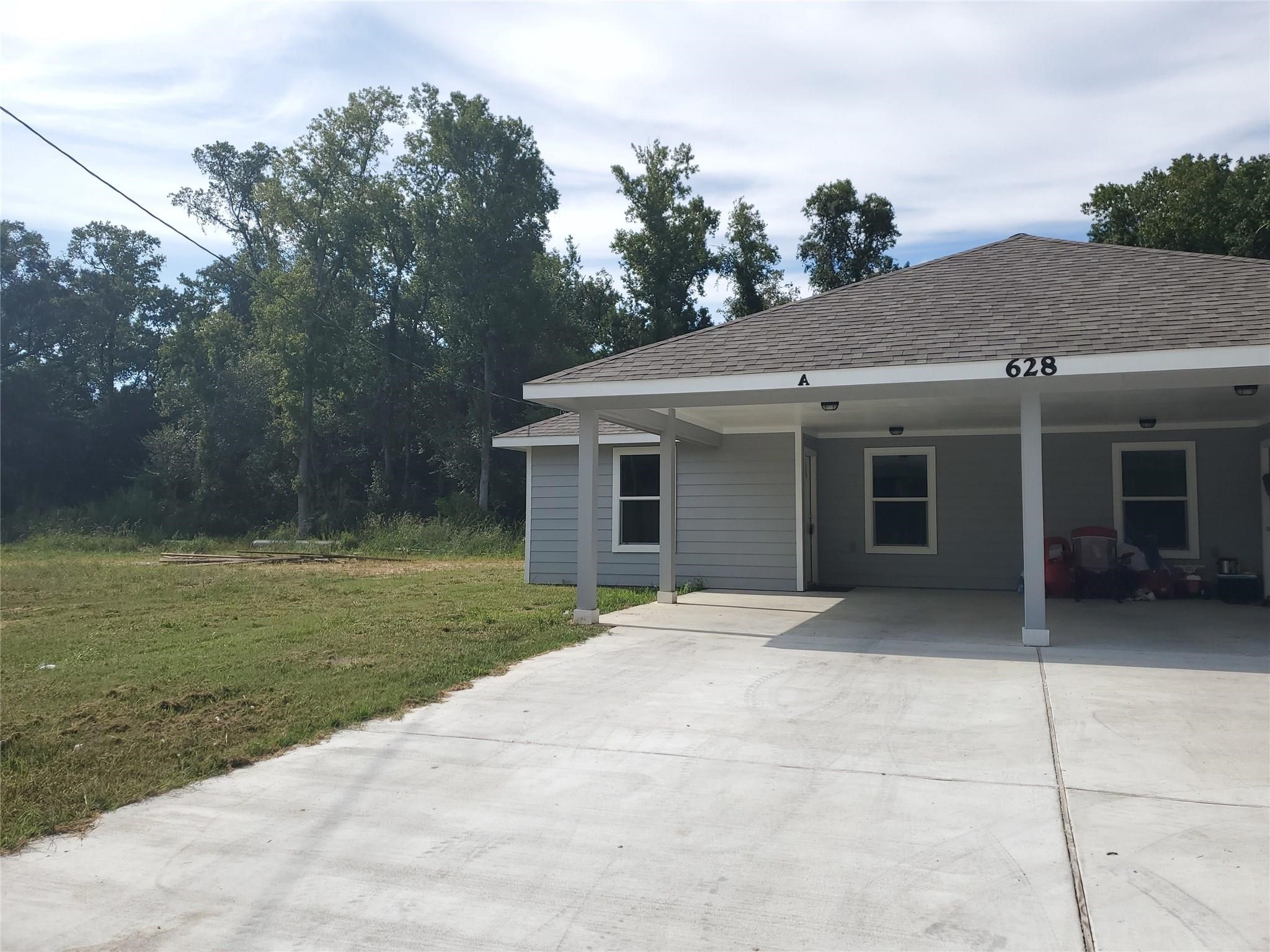 628 Luke Street, Unit A Dayton, TX 77535 - Photo 2 of 26 a front view of a house with a garden