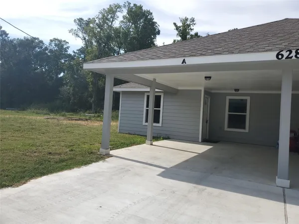 a backyard of a house with yard and garage