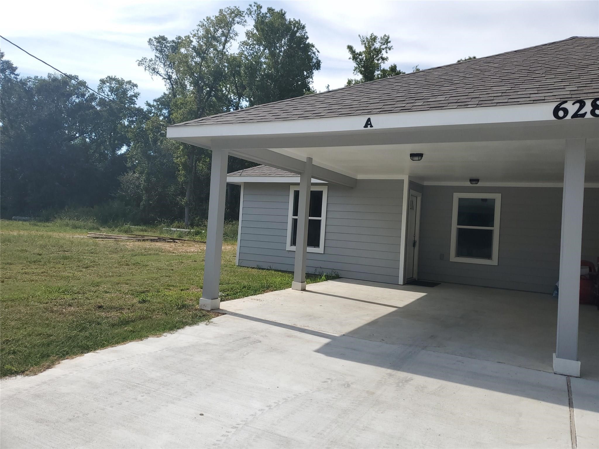 628 Luke Street, Unit A Dayton, TX 77535 - Photo 3 of 26 a backyard of a house with yard and garage