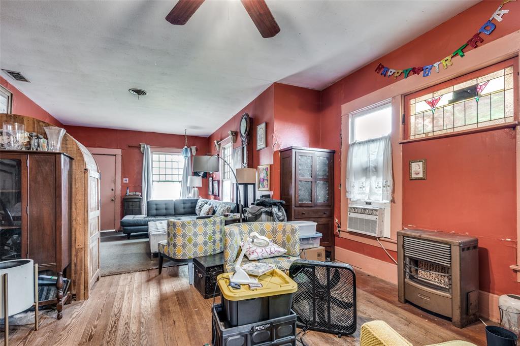 904 Haines Avenue Dallas, TX 75208 - Photo 8 of 24 a living room with furniture a flat screen tv and a refrigerator