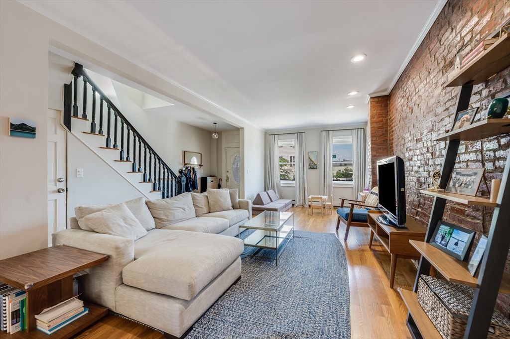 39 Emerson Street Boston, MA 02127 - Photo 1 of 20 a living room with furniture and a fireplace