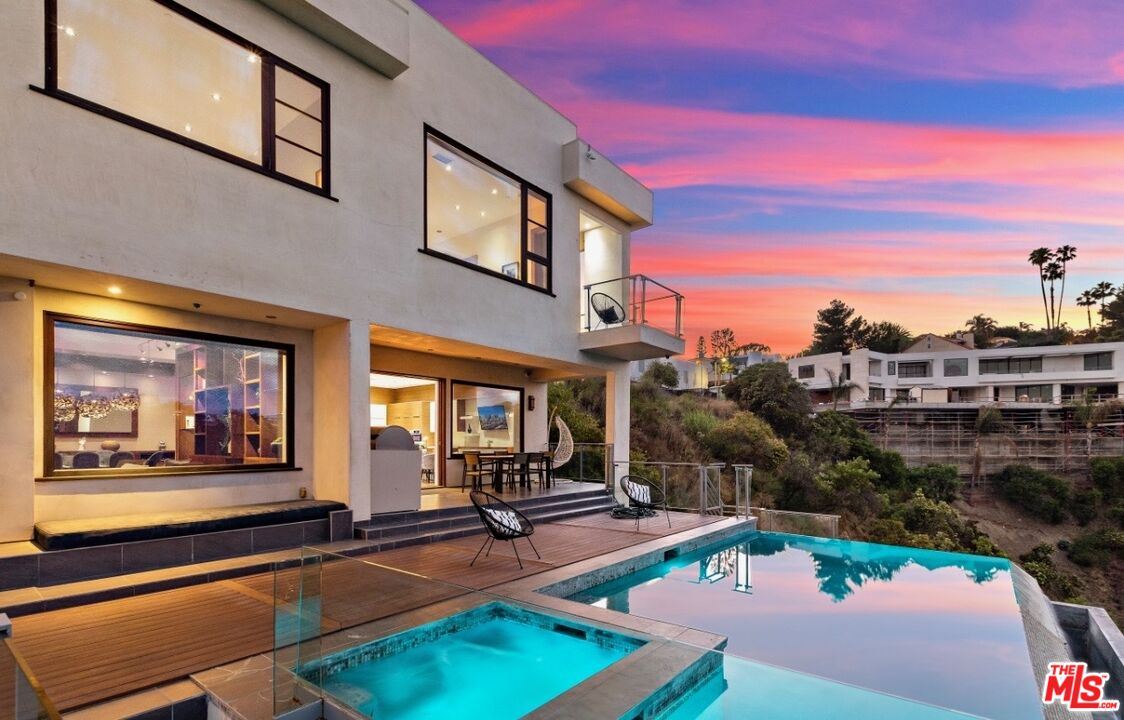 1018 Stradella Road Los Angeles, CA 90077 - Photo 1 of 22 a view of a building with sitting area