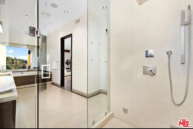 a bathroom with a shower and a sink