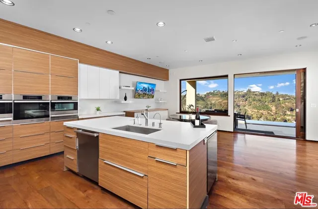 a kitchen with a sink and large window