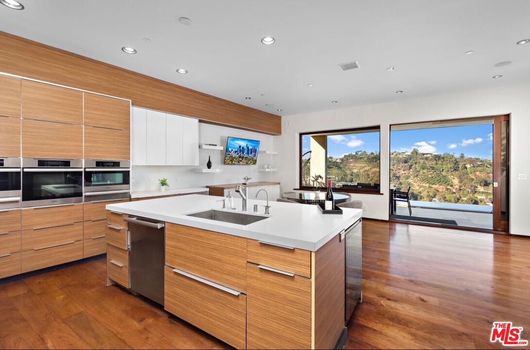 1018 Stradella Road Los Angeles, CA 90077 - Photo 15 of 22 a kitchen with a sink and large window