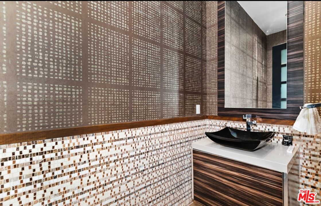 1018 Stradella Road Los Angeles, CA 90077 - Photo 17 of 22 a bathroom with a sink a bathtub and a shower