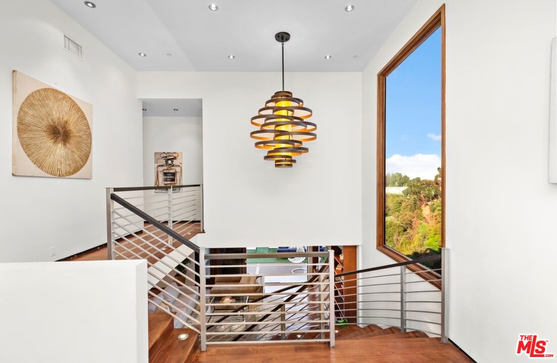 1018 Stradella Road Los Angeles, CA 90077 - Photo 18 of 22 a bedroom with a bed and a window