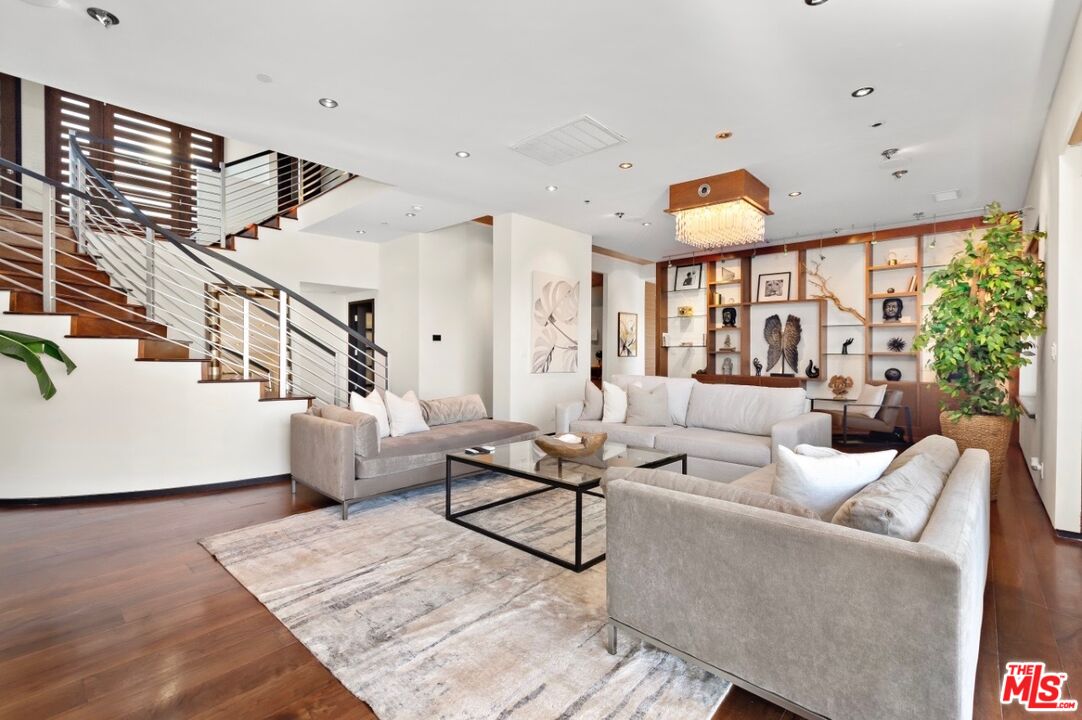 1018 Stradella Road Los Angeles, CA 90077 - Photo 19 of 22 a living room with furniture and wooden floor