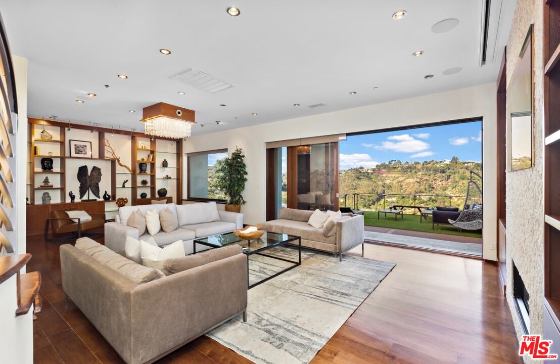1018 Stradella Road Los Angeles, CA 90077 - Photo 6 of 22 a living room with furniture and a large window
