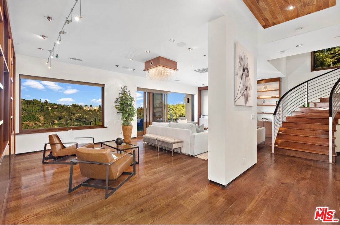 1018 Stradella Road Los Angeles, CA 90077 - Photo 7 of 22 a living room with furniture and a flat screen tv