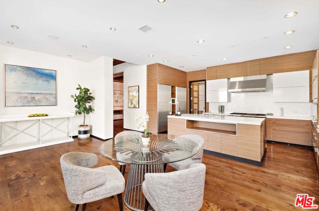 1018 Stradella Road Los Angeles, CA 90077 - Photo 8 of 22 a living room with kitchen island furniture and a large window