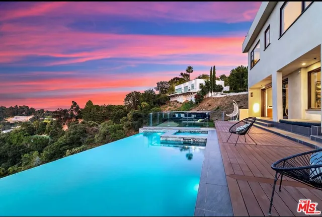 a view of a swimming pool with a table and chairs