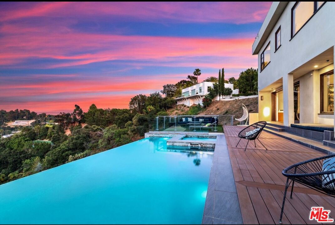 1018 Stradella Road Los Angeles, CA 90077 - Photo 10 of 22 a view of a swimming pool with a table and chairs