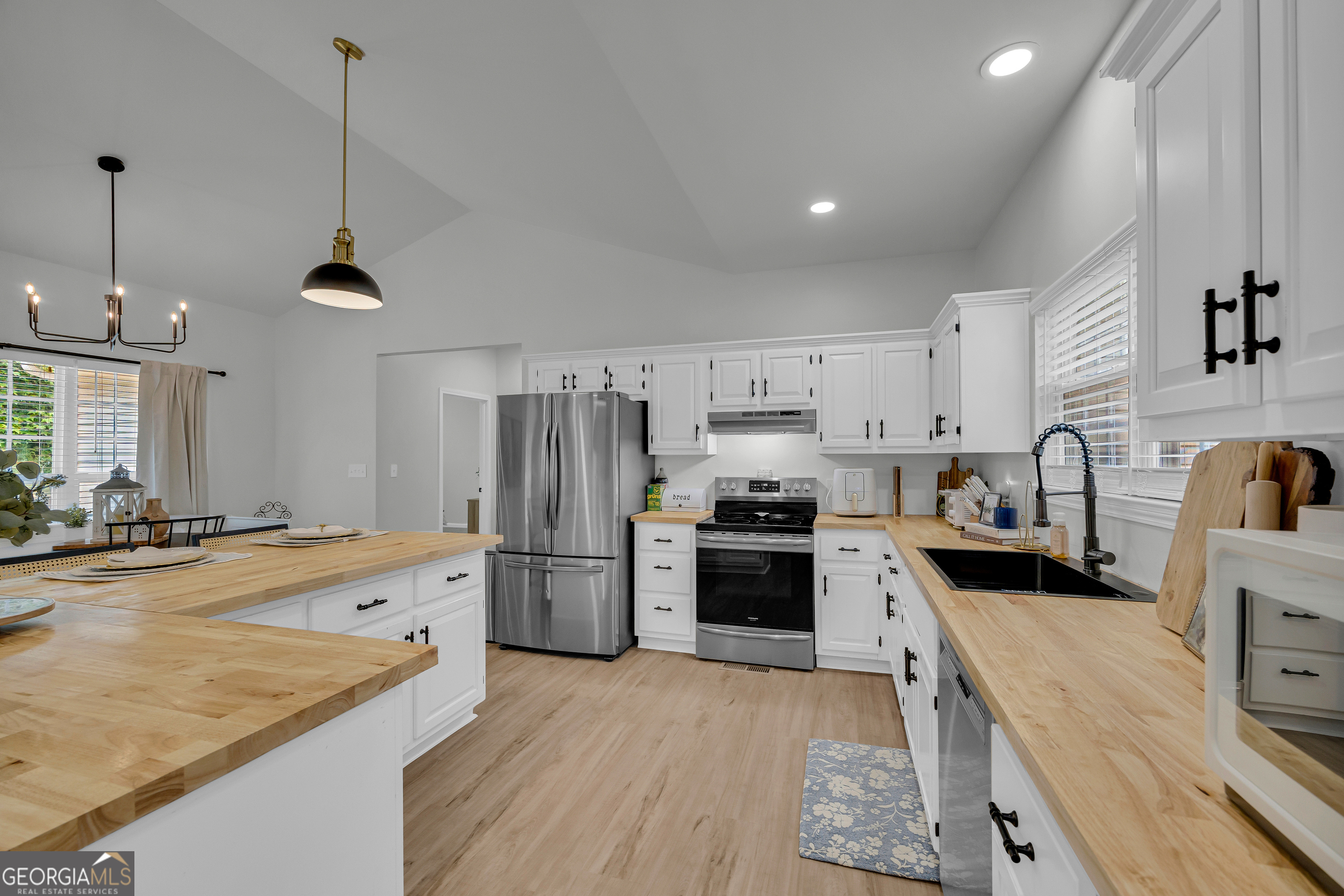 163 Tuxedo Drive Commerce, GA 30530 - Photo 25 of 62 a kitchen with refrigerator a stove and wooden floor