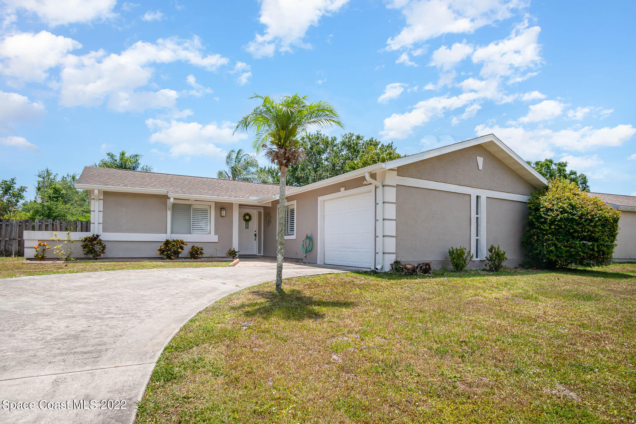1231 Freil Road Northeast Palm Bay, FL 32905 - Photo 1 of 22 a front view of house with yard and trees in the background