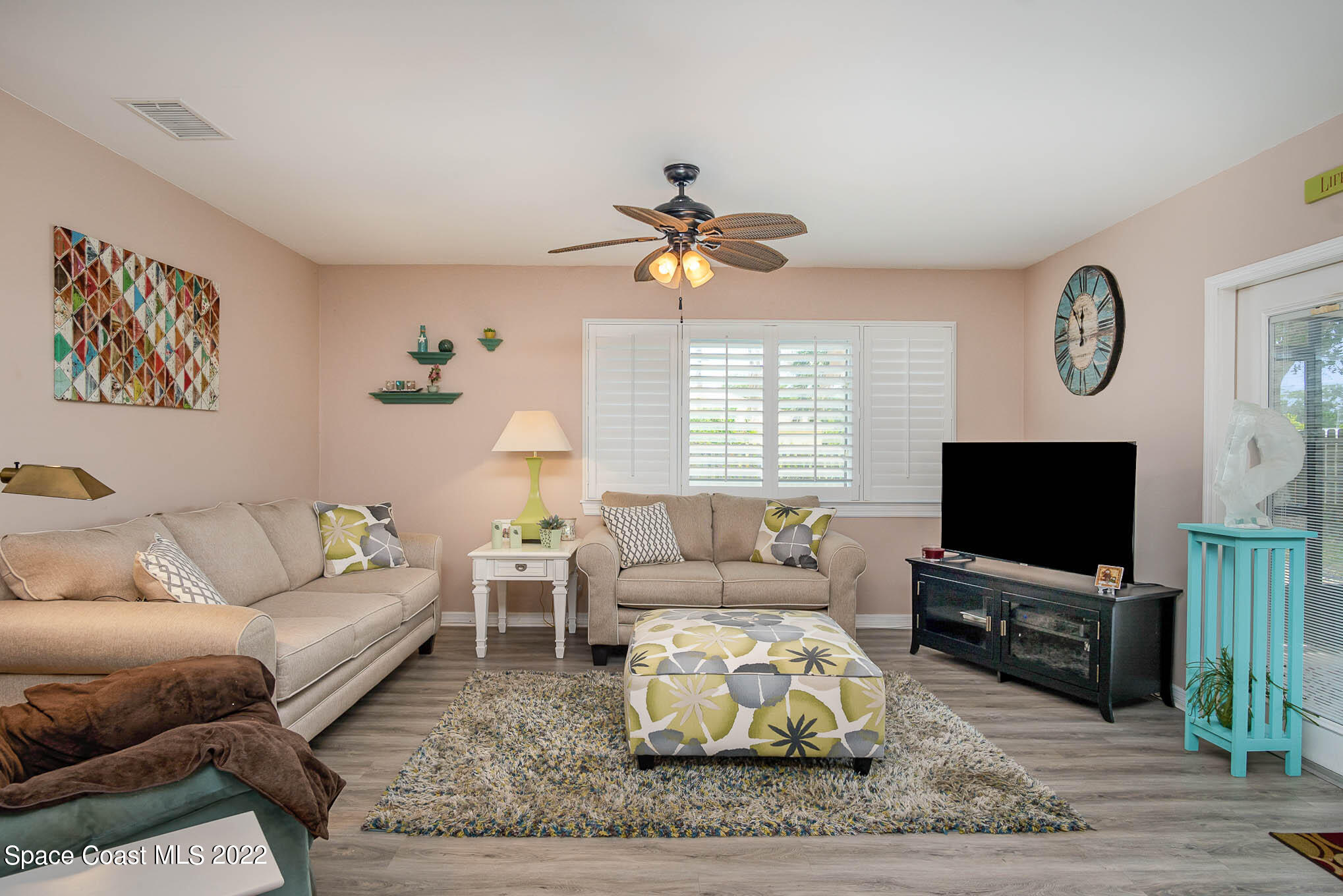 1231 Freil Road Northeast Palm Bay, FL 32905 - Photo 3 of 22 a living room with furniture a flat screen tv and a window
