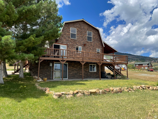 358 Maple Drive Fish Haven, ID 83287 - Photo 1 of 46 Stone veneer exterior with a gambrel roof and an expansive wood deck