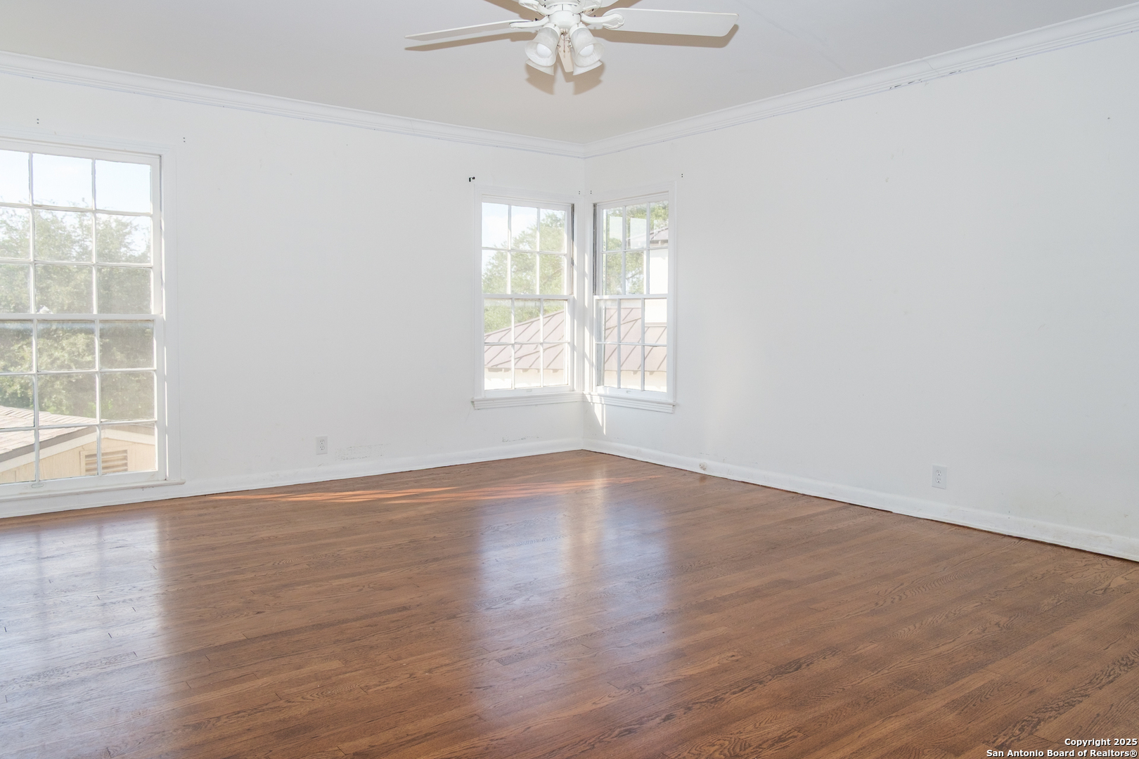 109 Dover Road San Antonio, TX 78209 - Photo 19 of 25 an empty room with wooden floor windows and fan
