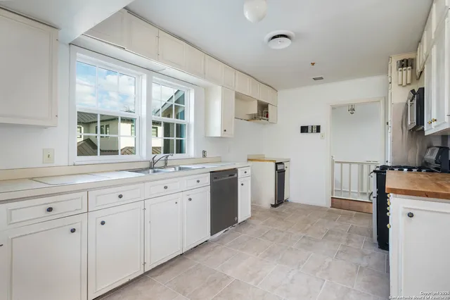 a kitchen with sink cabinets and appliances