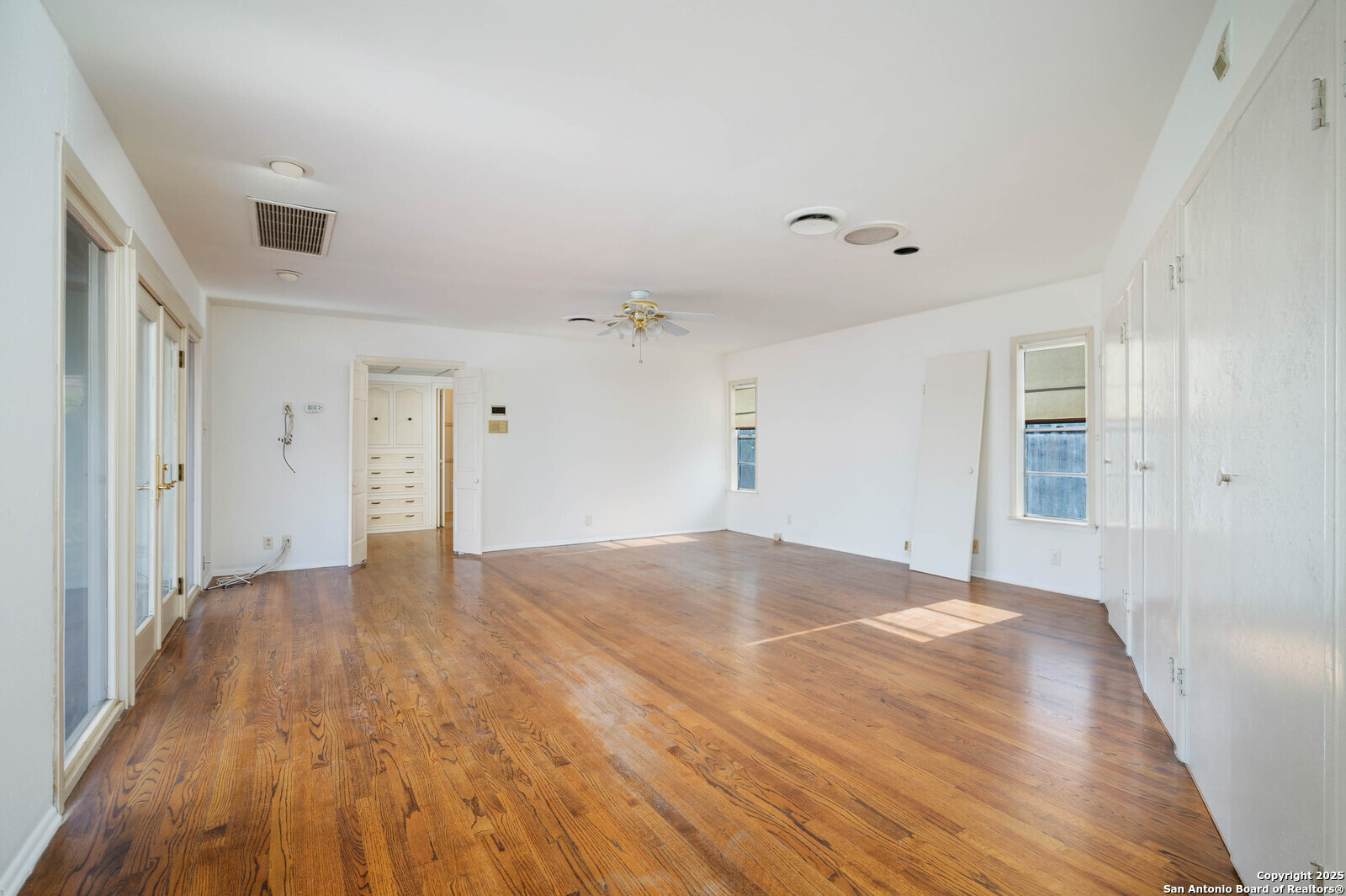 109 Dover Road San Antonio, TX 78209 - Photo 4 of 25 a view of empty room with wooden floor and fan
