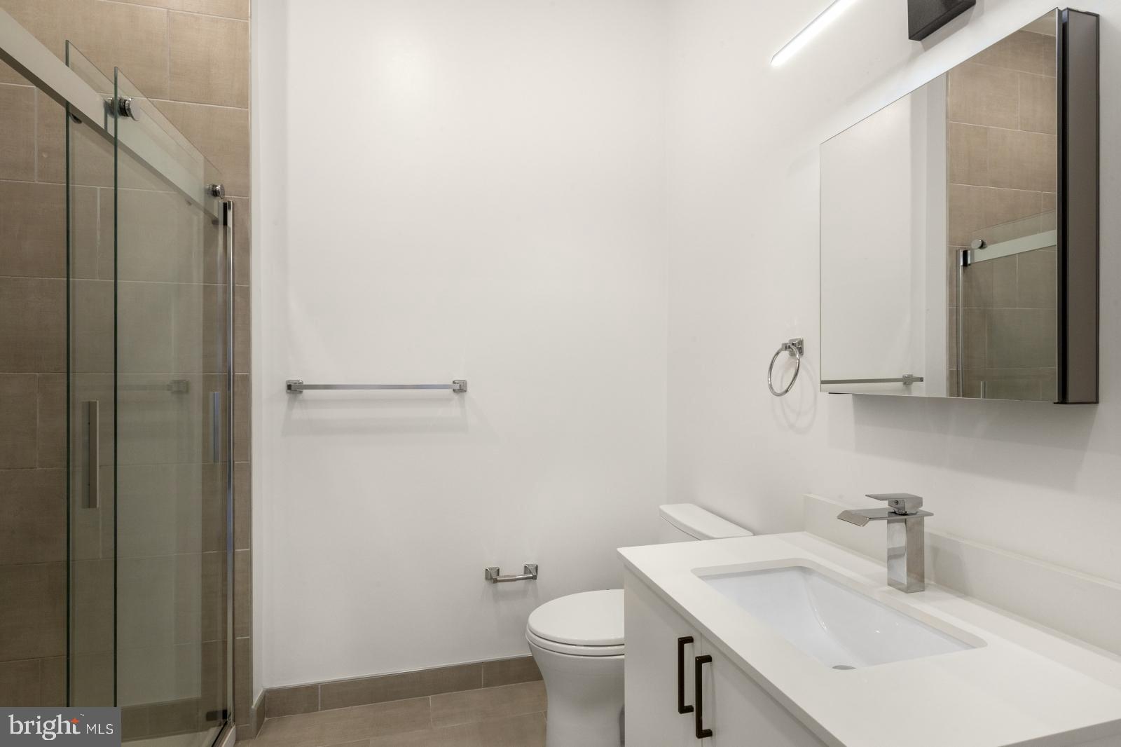1935 East Hazzard Street, Unit 201 Philadelphia, PA 19125 - Photo 10 of 20 a bathroom with a sink toilet and a mirror