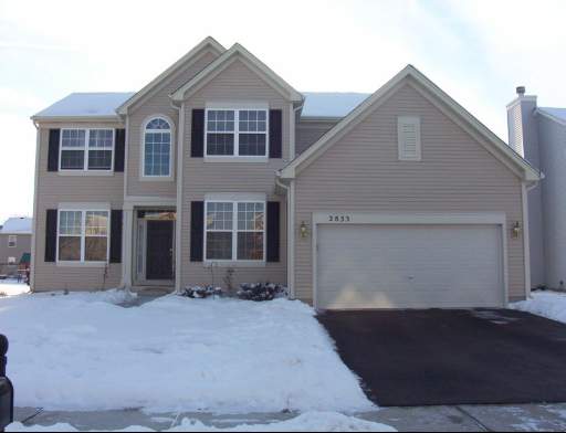2833 Rourke Drive Aurora, IL 60503 - Photo 1 of 1 a front view of brick house with a yard