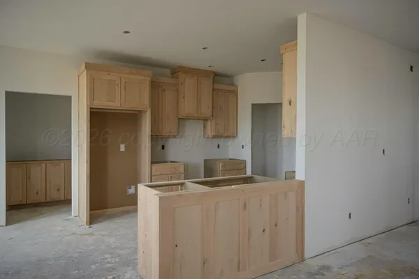 a room with a sink and cabinets