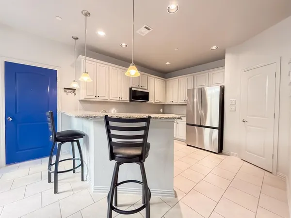 a kitchen with stainless steel appliances a refrigerator stove microwave and cabinets