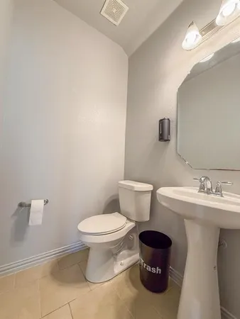 a bathroom with a sink toilet and a mirror