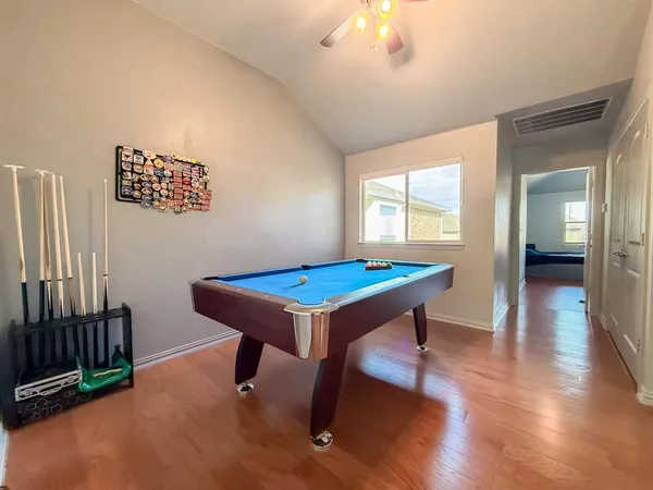 a room with furniture pool table and windows
