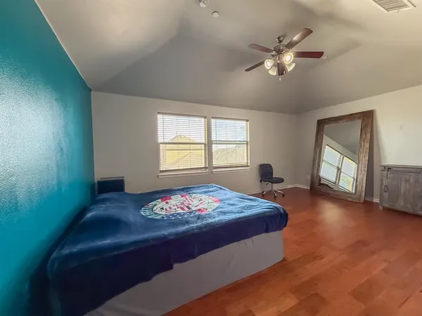 a bedroom with a bed and a chandelier