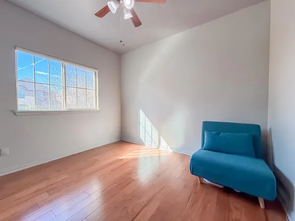 a view of room with window and wooden floor